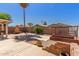 Well-maintained backyard featuring desert landscaping, a wooden shed, and mature palm trees at 716 E Horizon Heights Dr, San Tan Valley, AZ 85143