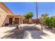 Beautiful backyard with a wooden shed, desert landscaping, and covered patio area at 716 E Horizon Heights Dr, San Tan Valley, AZ 85143