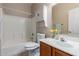 Bathroom features a tub/shower combo, matching vanity and toilet, and floral decor at 716 E Horizon Heights Dr, San Tan Valley, AZ 85143