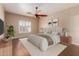 Relaxing bedroom featuring a ceiling fan, large window and plush bedding at 716 E Horizon Heights Dr, San Tan Valley, AZ 85143