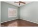 Bedroom features hardwood flooring, light teal walls, and a bright window at 716 E Horizon Heights Dr, San Tan Valley, AZ 85143