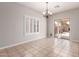 Bright dining area with tile floors, plantation shutters, and a sliding door to the backyard at 716 E Horizon Heights Dr, San Tan Valley, AZ 85143