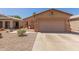 Charming single-story home with a two-car garage and low-maintenance desert landscaping at 716 E Horizon Heights Dr, San Tan Valley, AZ 85143