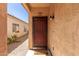 Inviting front entrance with a security screen door and a cozy 'homes' welcome mat at 716 E Horizon Heights Dr, San Tan Valley, AZ 85143
