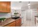 Kitchen features wooden cabinets, dark sink, and tiled flooring at 716 E Horizon Heights Dr, San Tan Valley, AZ 85143
