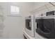 Practical laundry area with modern machines and shelving for storage at 716 E Horizon Heights Dr, San Tan Valley, AZ 85143