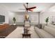 Bright living room with plush sofa, modern ceiling fan, and large windows at 716 E Horizon Heights Dr, San Tan Valley, AZ 85143