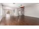 Spacious living room with beautiful dark hardwood floors, neutral walls, and a ceiling fan at 716 E Horizon Heights Dr, San Tan Valley, AZ 85143