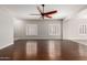 Bright living room featuring dark hardwood floors, neutral walls, and plantation shutters at 716 E Horizon Heights Dr, San Tan Valley, AZ 85143