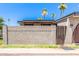 A charming home is adorned with decorative cinder block and a gated wooden fence entry, enhancing curb appeal at 830 S Dobson Rd # 86, Mesa, AZ 85202