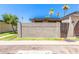 A charming home is adorned with decorative cinder block and a gated wooden fence entry, enhancing curb appeal at 830 S Dobson Rd # 86, Mesa, AZ 85202