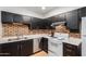 The kitchen features black cabinets, a brick backsplash, and modern appliances, creating a functional space at 830 S Dobson Rd # 86, Mesa, AZ 85202