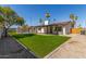 Spacious backyard with a pool, covered patio, and lush green lawn for outdoor enjoyment at 8602 N 42Nd Dr, Phoenix, AZ 85051
