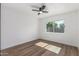 Bright bedroom featuring modern ceiling fan, wood floors and a sunlit window at 8602 N 42Nd Dr, Phoenix, AZ 85051