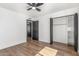 This bedroom features modern wood floors, ceiling fan, and closet with shelving at 8602 N 42Nd Dr, Phoenix, AZ 85051