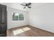 Bright bedroom featuring modern ceiling fan, wood floors and a sunlit window at 8602 N 42Nd Dr, Phoenix, AZ 85051
