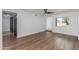 Bright bedroom featuring wood-look floors, a modern ceiling fan, large window, and ample closet space at 8602 N 42Nd Dr, Phoenix, AZ 85051