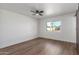 Bedroom with ceiling fan, wood-look floors, neutral walls, and sliding barn door at 8602 N 42Nd Dr, Phoenix, AZ 85051