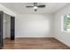 Bedroom with ceiling fan, wood-look floors, neutral walls, and large closet at 8602 N 42Nd Dr, Phoenix, AZ 85051