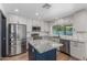Kitchen with stainless steel appliances, center island, stone countertops and neutral tiling at 8602 N 42Nd Dr, Phoenix, AZ 85051