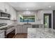 Kitchen with stainless steel appliances, stone countertops, neutral tiling, and eat-in breakfast nook at 8602 N 42Nd Dr, Phoenix, AZ 85051