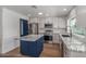 Kitchen with stainless steel appliances, center island, stone countertops and neutral tiling at 8602 N 42Nd Dr, Phoenix, AZ 85051