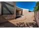 Gravel backyard with a brick border and a view of the covered patio at 8725 E Vía Del Arbor --, Scottsdale, AZ 85258