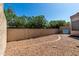 Backyard featuring a gravel area, brick border, and tall privacy wall at 8725 E Vía Del Arbor --, Scottsdale, AZ 85258