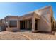 Backyard with gravel, brick border, covered patio, and sliding glass doors at 8725 E Vía Del Arbor --, Scottsdale, AZ 85258