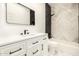 Modern bathroom features sleek white vanity, black accents, and decorative shower at 8725 E Vía Del Arbor --, Scottsdale, AZ 85258
