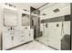 Modern bathroom with dual sinks, a glass-enclosed shower, and marble flooring at 8725 E Vía Del Arbor --, Scottsdale, AZ 85258