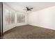 Bright bedroom with new carpet, ceiling fan, and large windows with blinds at 8725 E Vía Del Arbor --, Scottsdale, AZ 85258