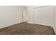 Bedroom with a closet, neutral carpeting, freshly painted white walls, and white trim at 8725 E Vía Del Arbor --, Scottsdale, AZ 85258
