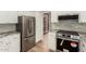 Updated kitchen with stainless steel appliances, granite counters, and white cabinets at 8725 E Vía Del Arbor --, Scottsdale, AZ 85258