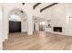 Open-concept living room boasting a fireplace, wood floors, and high ceilings at 8725 E Vía Del Arbor --, Scottsdale, AZ 85258
