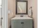 Powder room featuring a green vanity, marble top, and black framed mirror at 8939 W Villa Rita Dr, Peoria, AZ 85382