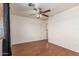 Well-lit bedroom features wood-look floors, a ceiling fan, and white walls at 8939 W Villa Rita Dr, Peoria, AZ 85382