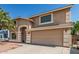 Two-story home with desert landscaping, attached two-car garage, and desert landscaping with palm trees at 8939 W Villa Rita Dr, Peoria, AZ 85382