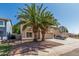 View of a two story home with desert landscaping, palm trees, and an attached two-car garage at 8939 W Villa Rita Dr, Peoria, AZ 85382