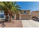 Two-story home with desert landscaping, attached two-car garage, and desert landscaping with palm trees at 8939 W Villa Rita Dr, Peoria, AZ 85382