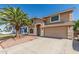 Two-story home with desert landscaping, attached two-car garage, and desert landscaping with palm trees at 8939 W Villa Rita Dr, Peoria, AZ 85382