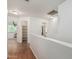 Spacious hallway with wood-look floors provides access to bedrooms and a utility closet at 8939 W Villa Rita Dr, Peoria, AZ 85382
