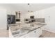 Bright kitchen featuring white cabinets, granite countertops, stainless steel appliances, and tile flooring at 8939 W Villa Rita Dr, Peoria, AZ 85382