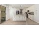 Bright kitchen featuring an island with granite countertops and white cabinets with stainless steel appliances at 8939 W Villa Rita Dr, Peoria, AZ 85382