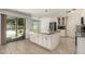 Bright kitchen with a center island with granite countertops and stainless steel appliances and a patio door at 8939 W Villa Rita Dr, Peoria, AZ 85382