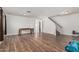 Bright living room with wood-look floors, staircase, table and neutral walls offers a spacious design at 8939 W Villa Rita Dr, Peoria, AZ 85382
