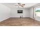 Spacious living room featuring wood-look floors, neutral walls, and ceiling fan with natural light at 8939 W Villa Rita Dr, Peoria, AZ 85382