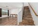 Open-concept living room with wood-look floors, a staircase, and natural light at 8939 W Villa Rita Dr, Peoria, AZ 85382