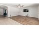 Open living room with wood-look floors transitioning into tile and an open floor plan at 8939 W Villa Rita Dr, Peoria, AZ 85382