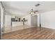 Open-concept living and kitchen space featuring wood-look floors, tile, white cabinets and neutral walls at 8939 W Villa Rita Dr, Peoria, AZ 85382